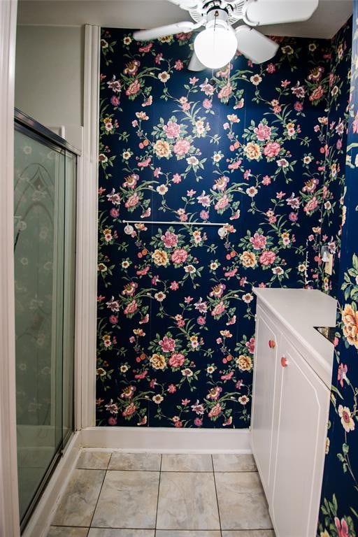 bathroom featuring tile patterned flooring, ceiling fan, and walk in shower