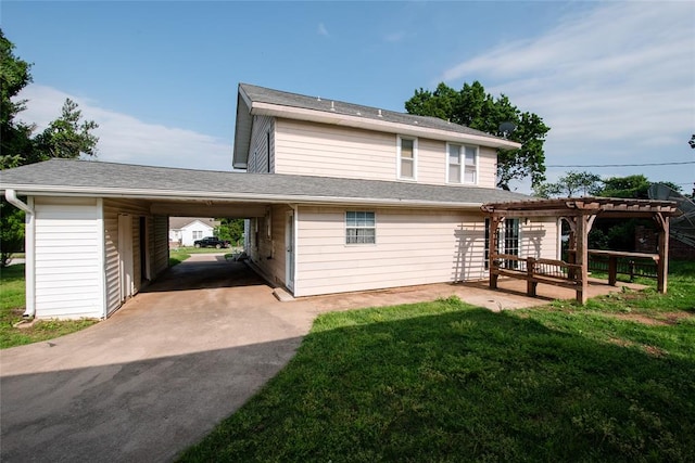 back of property featuring a yard and a carport