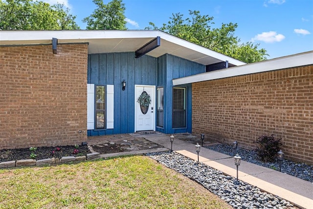 doorway to property featuring a yard