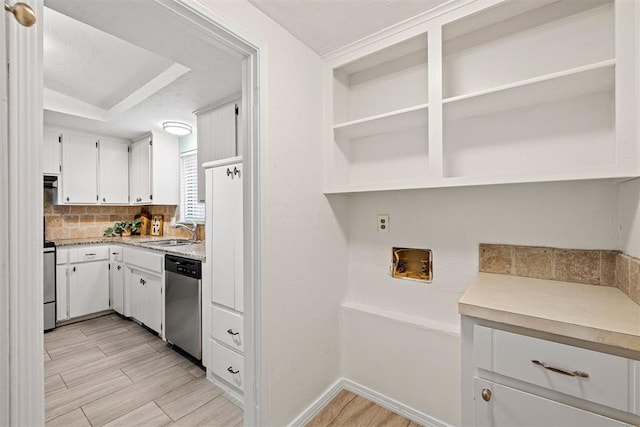 kitchen featuring decorative backsplash, dishwasher, white cabinets, and sink