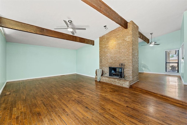 unfurnished living room featuring lofted ceiling with beams, ceiling fan, wood-type flooring, and a brick fireplace