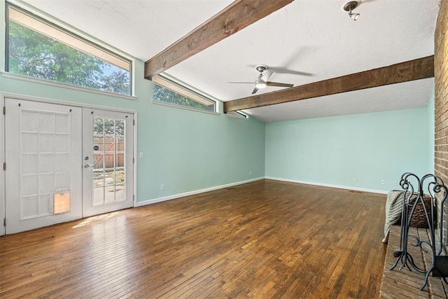 unfurnished living room featuring ceiling fan, dark hardwood / wood-style floors, lofted ceiling with beams, and french doors