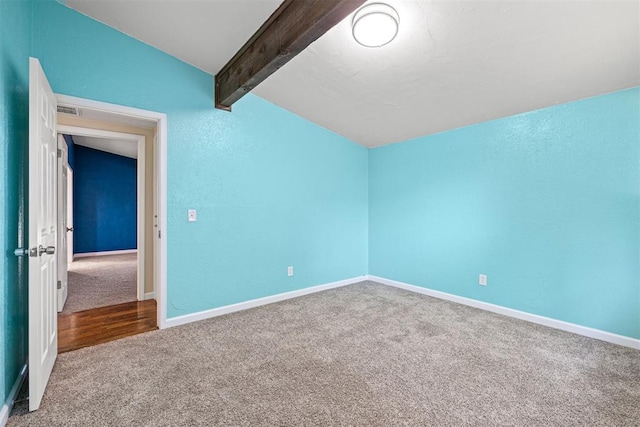 additional living space featuring lofted ceiling with beams and carpet floors