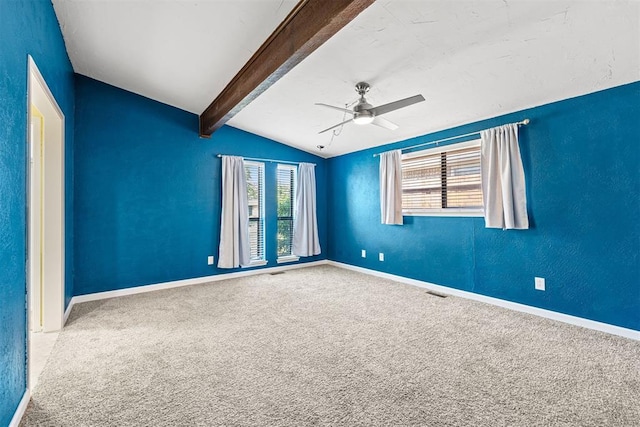 carpeted spare room with vaulted ceiling with beams and ceiling fan