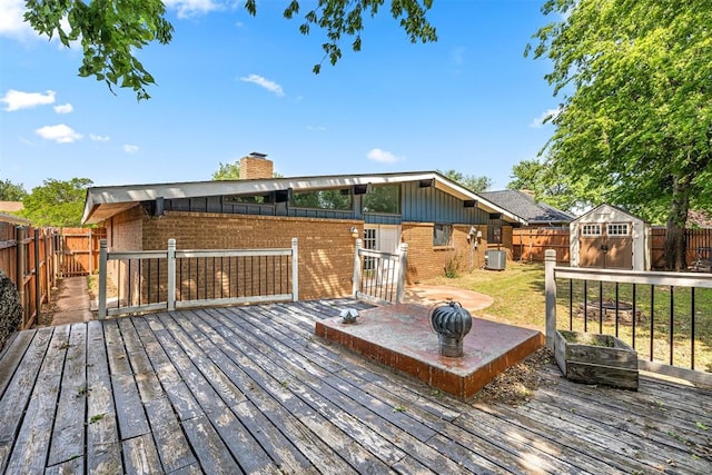 wooden deck with a storage shed and central air condition unit