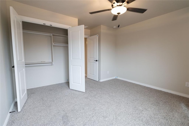 unfurnished bedroom with ceiling fan, a closet, and light carpet