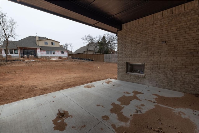 view of patio with an outdoor brick fireplace