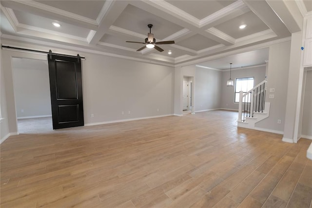 unfurnished living room featuring ceiling fan, crown molding, a barn door, and coffered ceiling