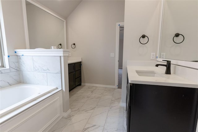 bathroom with vaulted ceiling, a tub to relax in, and vanity