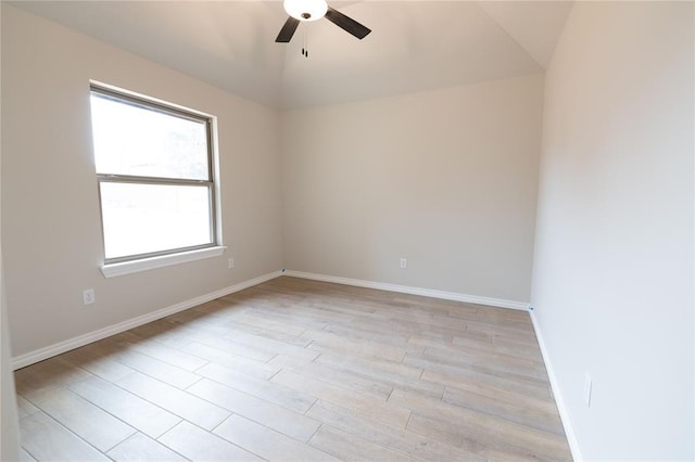 spare room featuring ceiling fan, lofted ceiling, and light hardwood / wood-style flooring