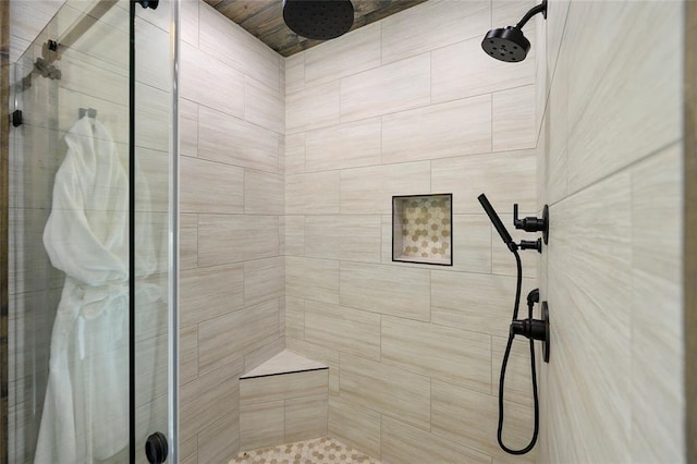 bathroom with a shower with door