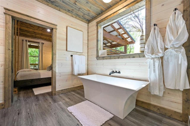 bathroom with wooden walls, wooden ceiling, and hardwood / wood-style flooring