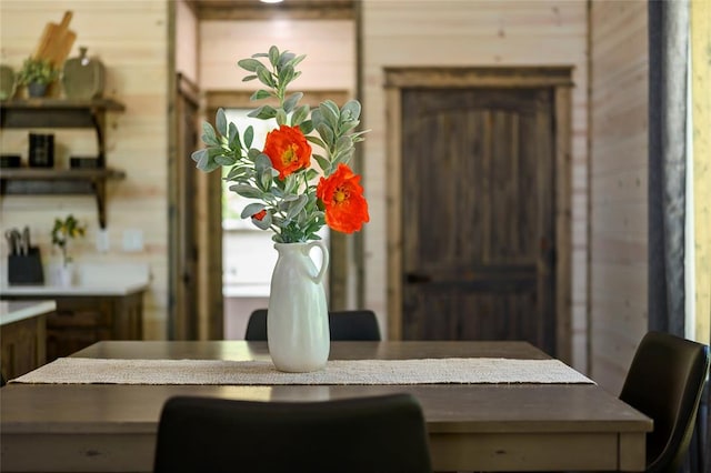 dining area featuring wood walls