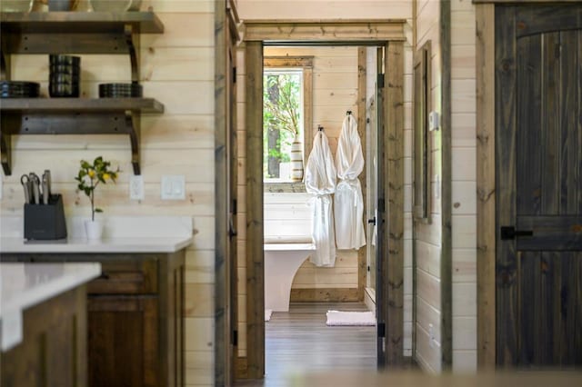 interior space with wooden walls and hardwood / wood-style floors