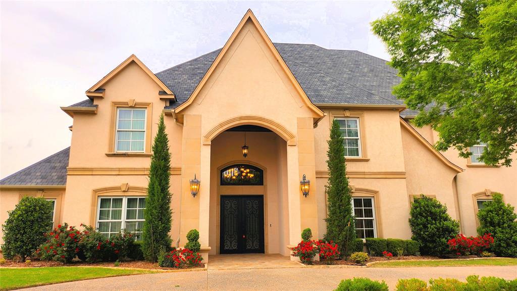 view of exterior entry with stucco siding and french doors