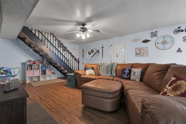 living room with wood-type flooring, a textured ceiling, and ceiling fan