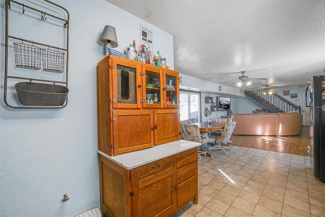 interior space with ceiling fan and light hardwood / wood-style floors