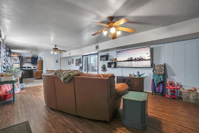 living room with wood-type flooring and a textured ceiling