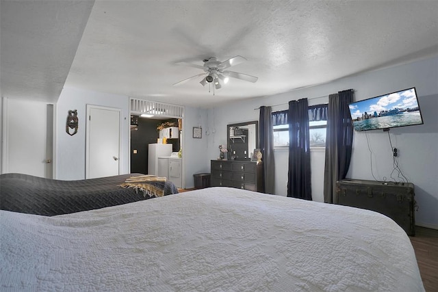 bedroom with a textured ceiling, hardwood / wood-style flooring, and ceiling fan