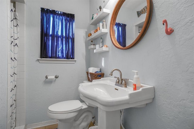 bathroom with toilet and a shower