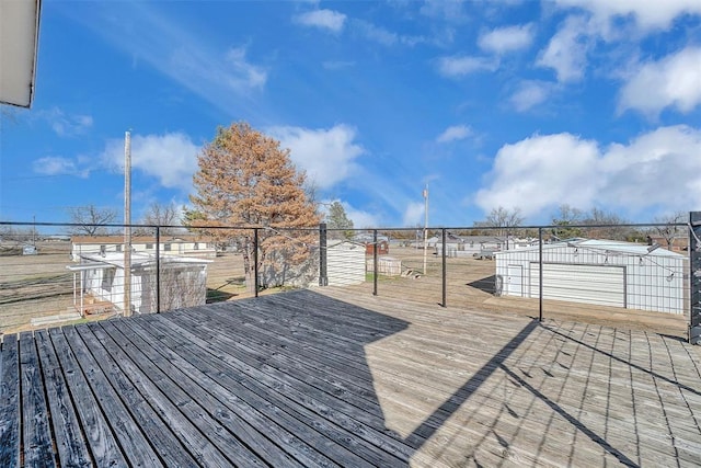 deck with a garage and an outbuilding