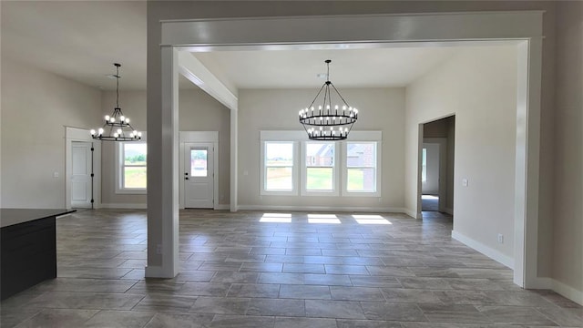 unfurnished dining area with an inviting chandelier and a healthy amount of sunlight