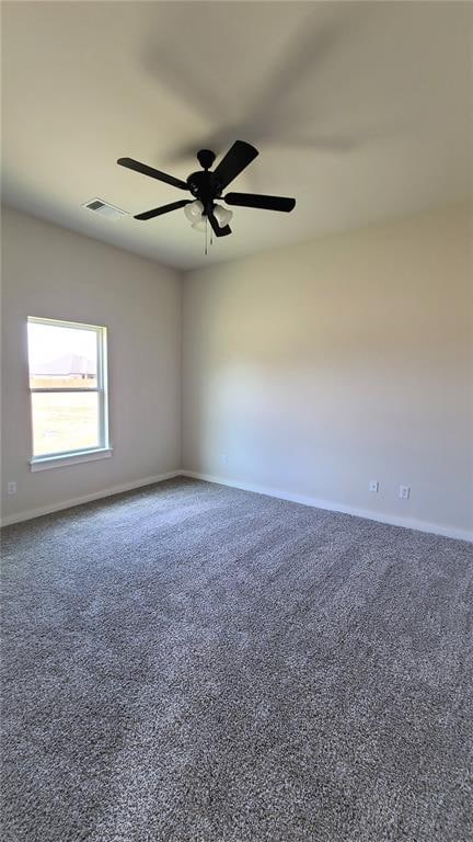 carpeted spare room with ceiling fan