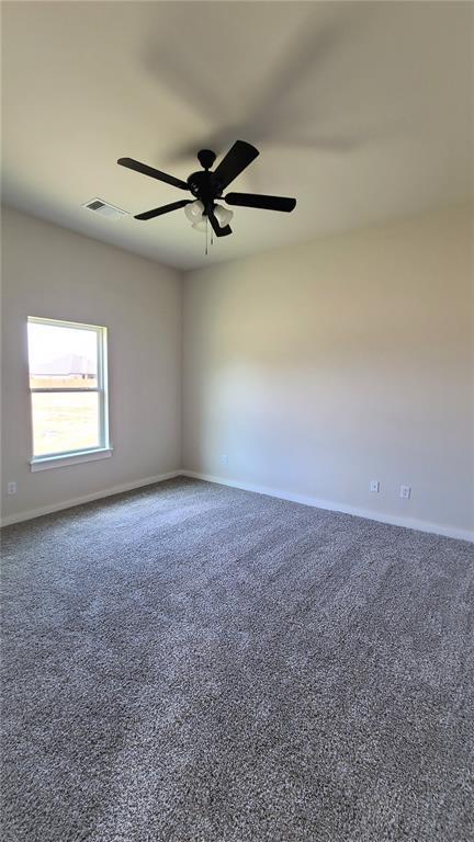 200 Braxton Way, Yukon, OK 73099 - spare room with carpet floors, baseboards, and ceiling fan