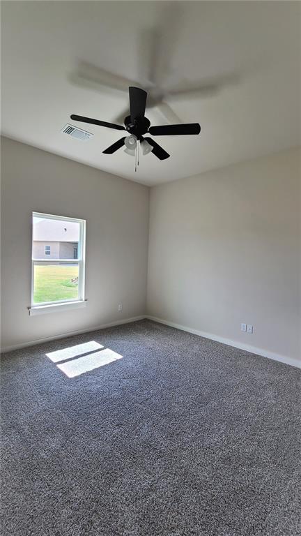 carpeted empty room with ceiling fan