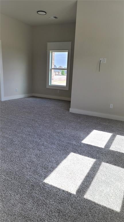 empty room featuring dark colored carpet