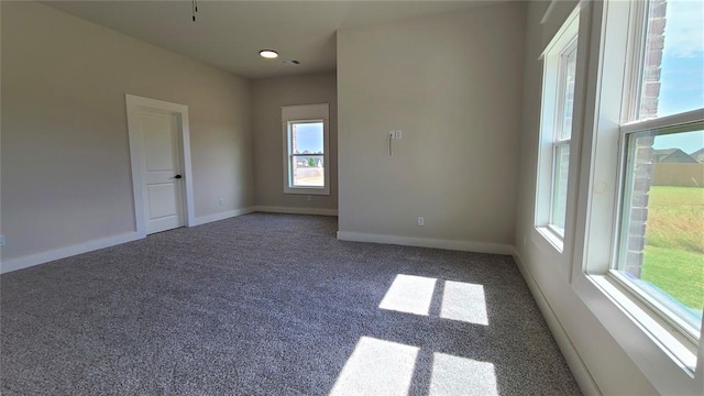 carpeted empty room with plenty of natural light