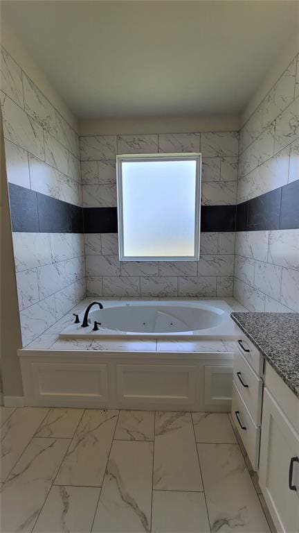 200 Braxton Way, Yukon, OK 73099 - bathroom with tile walls, marble finish flooring, a tub with jets, and vanity