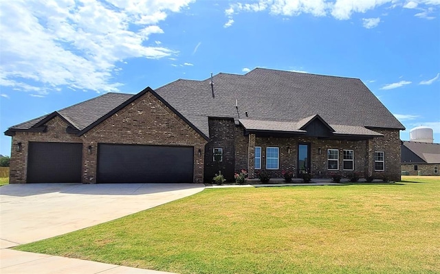 view of front of home featuring a garage and a front yard