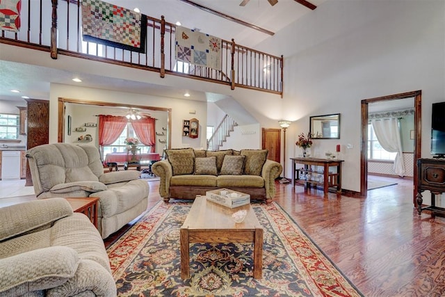 living room featuring plenty of natural light, a high ceiling, and hardwood / wood-style flooring