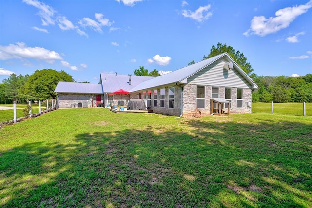 rear view of property featuring a yard