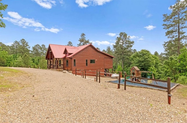 view of property exterior with a playground