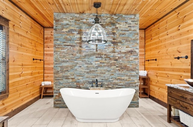 bathroom with a bathing tub, vanity, wood ceiling, and wooden walls