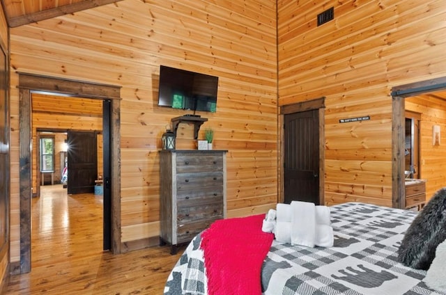 bedroom with a high ceiling and light hardwood / wood-style floors