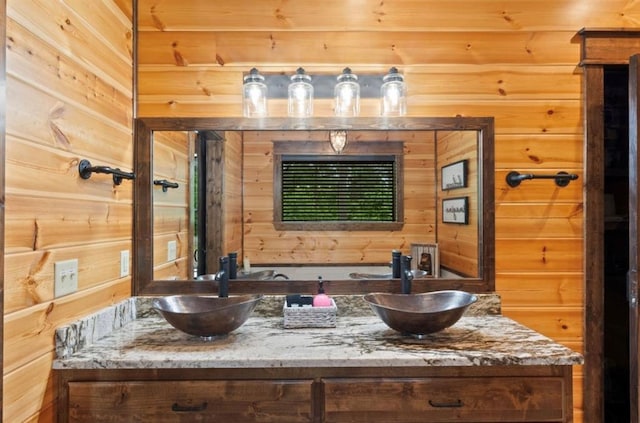 bathroom featuring vanity and wooden walls