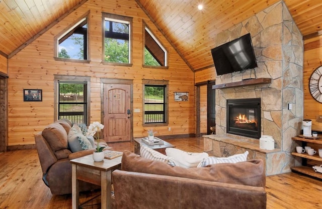 living room featuring wood walls, high vaulted ceiling, light hardwood / wood-style floors, and wooden ceiling