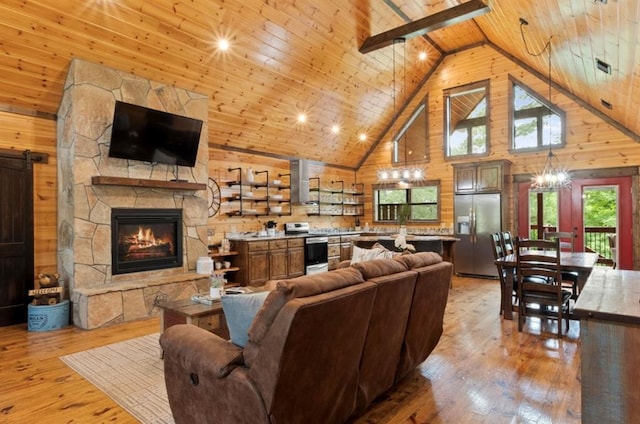 living room featuring wooden walls, light hardwood / wood-style floors, wood ceiling, and high vaulted ceiling