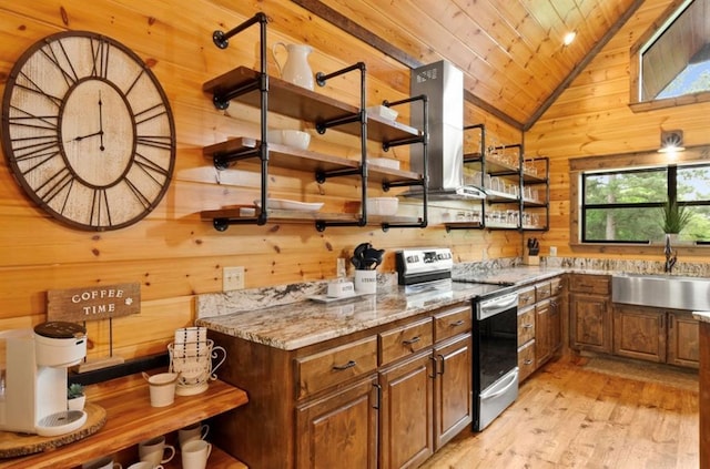 kitchen with stainless steel electric range oven, wooden walls, wooden ceiling, and light hardwood / wood-style flooring