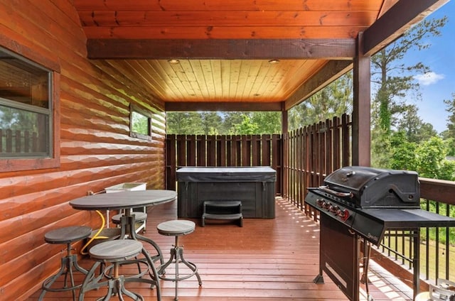 wooden terrace with a hot tub and a grill