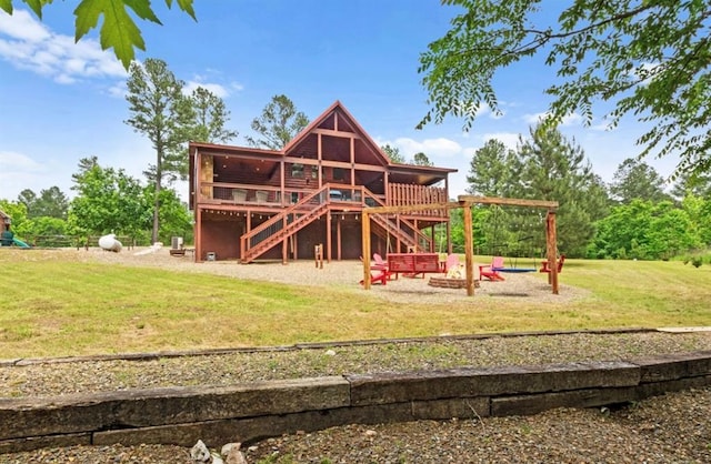 exterior space with a lawn, a fire pit, and a deck