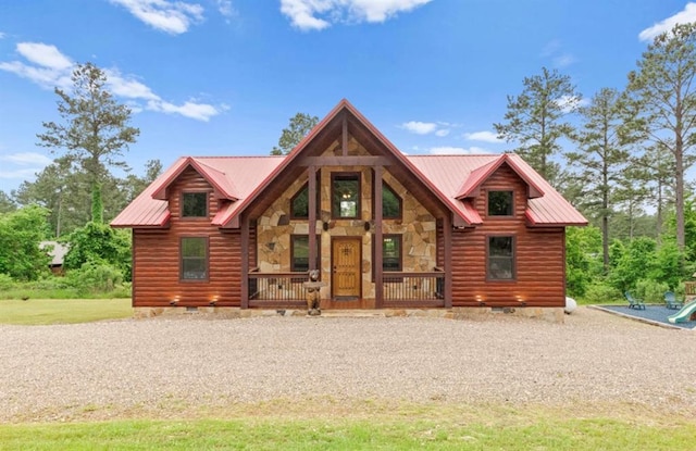 log home with stone siding, crawl space, covered porch, faux log siding, and metal roof