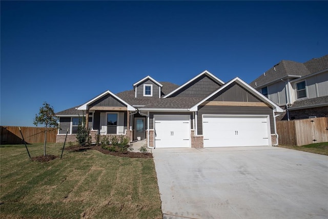 craftsman house featuring a front yard and a garage