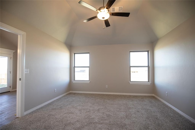 spare room with wood-type flooring, vaulted ceiling, ceiling fan, and a healthy amount of sunlight