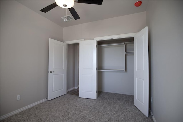 unfurnished bedroom with ceiling fan, a closet, and carpet floors