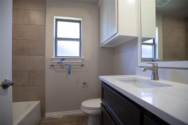 bathroom featuring toilet, vanity, and hardwood / wood-style flooring