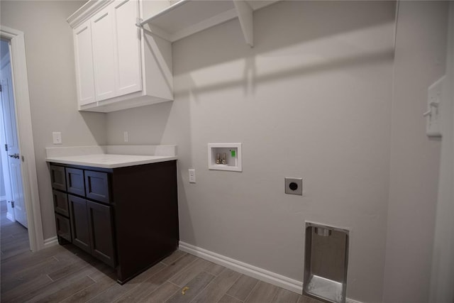 laundry room featuring hookup for an electric dryer, dark wood-type flooring, cabinets, and washer hookup